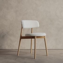 The Castello Dining Table - Natural features a modern light wood design, perfect for dining spaces, and stands elegantly against a beige textured wall.