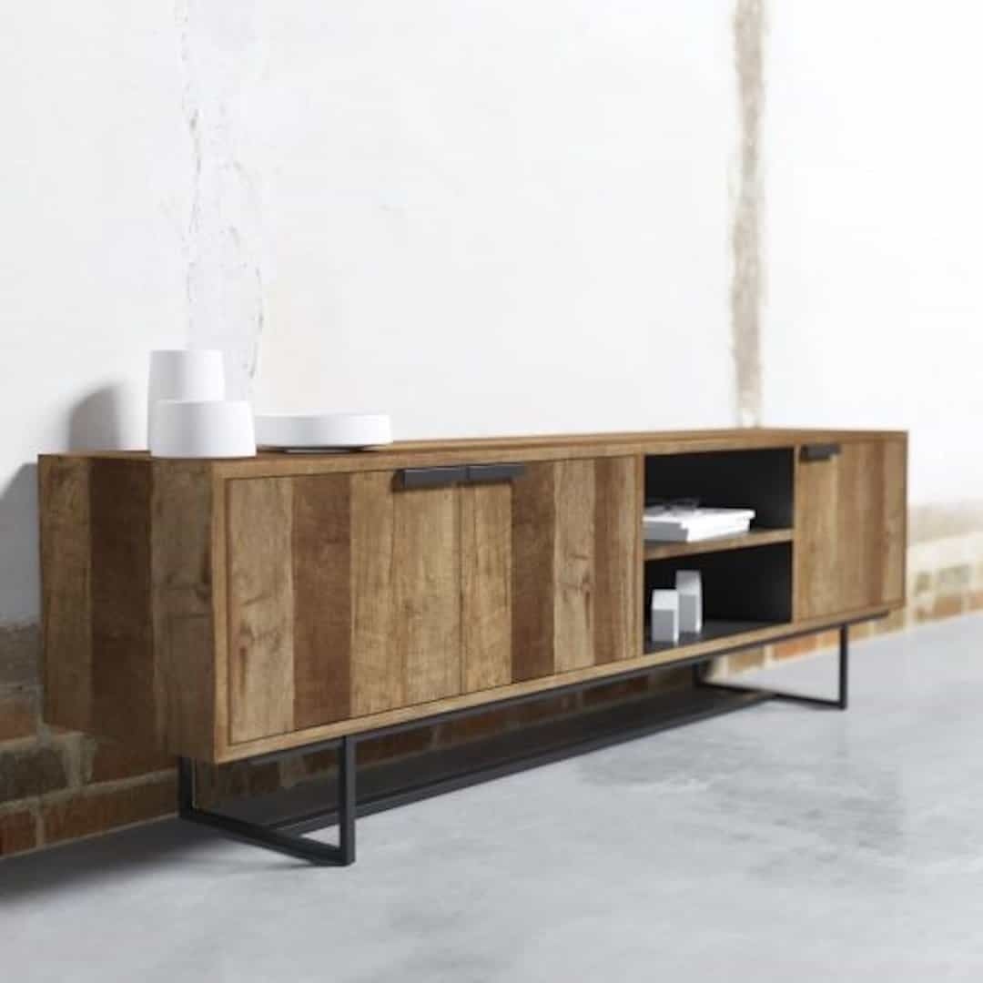 78″ 3 Door Console-03 A 3 Door Parisian Factory 78″ TV Console with two closed cabinets and open shelving, containing a few decorative items, stands against a concrete wall.