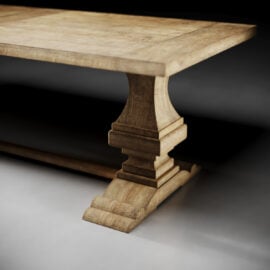 A close-up view of the Castello Dining Table - Natural, featuring a thick rectangular wooden top and a sculpted pedestal base.