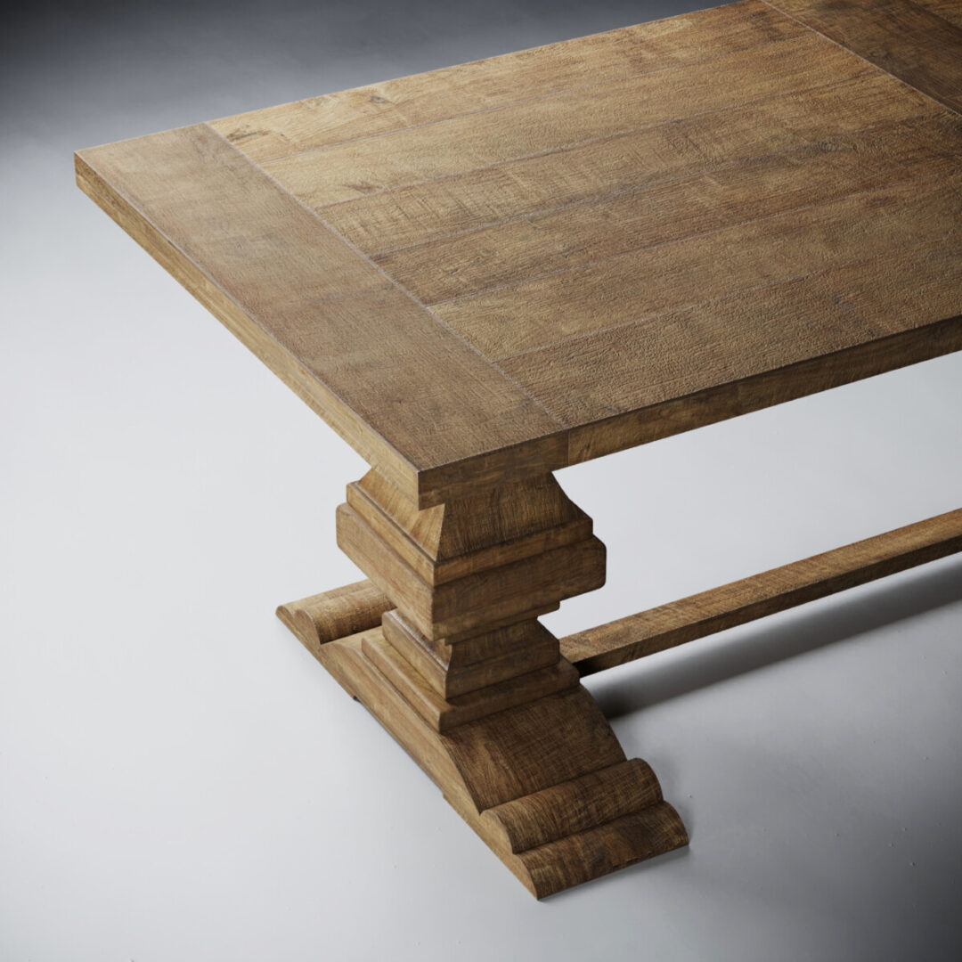 CASTELLO NATURAL- ADDITIONAL 5 Close-up of the Castello Dining Table - Natural, featuring a thick rectangular wooden top and an ornate tiered pedestal base, set on a light grey surface.