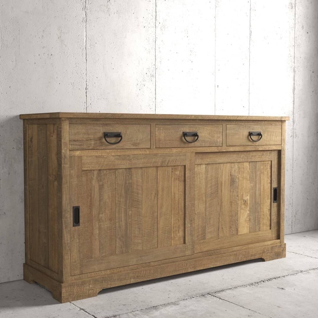 Urban Woodcraft 65 Riverbend Dining Buffet - Natural (3) The Riverbend Sliding Door Dining Buffet, featuring three top drawers and two sliding doors below, stands against a concrete wall.