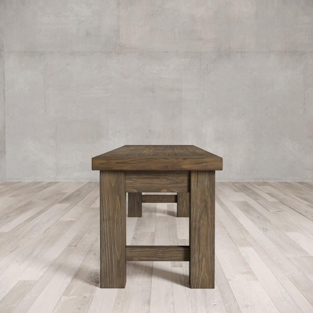 Urban Woodcraft 70 Squre Bench - Salvaged Espresso (3) A Square Dining Bench with a rectangular top and thick legs stands on a light-colored floor against a plain grey wall.