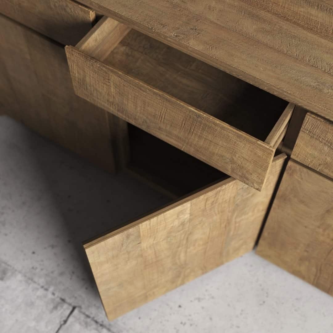 Urban Woodcraft 75 Teca Dining Buffet - Natural (5) The Teca Dining Buffet, featuring a textured wood finish, stands on a gray concrete floor with its two drawers partially open.