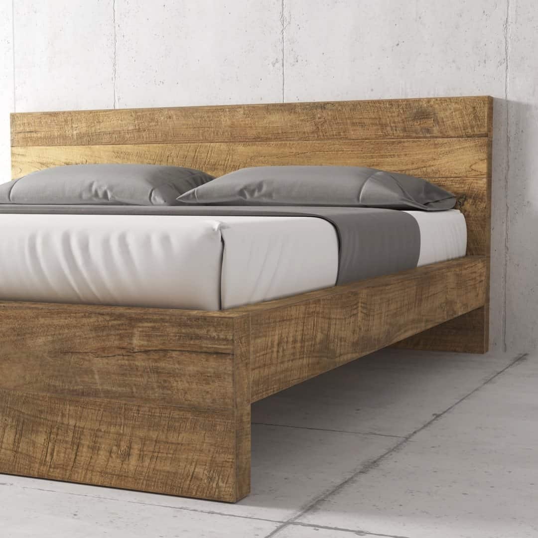 Urban Woodcraft Lugano Bed - Natural (3) The Lugano Bed, crafted from wood and boasting a rustic finish, features a high headboard. It is impeccably dressed with white sheets, a grey bedrunner, and two grey pillows. The background reveals a plain concrete wall and floor.