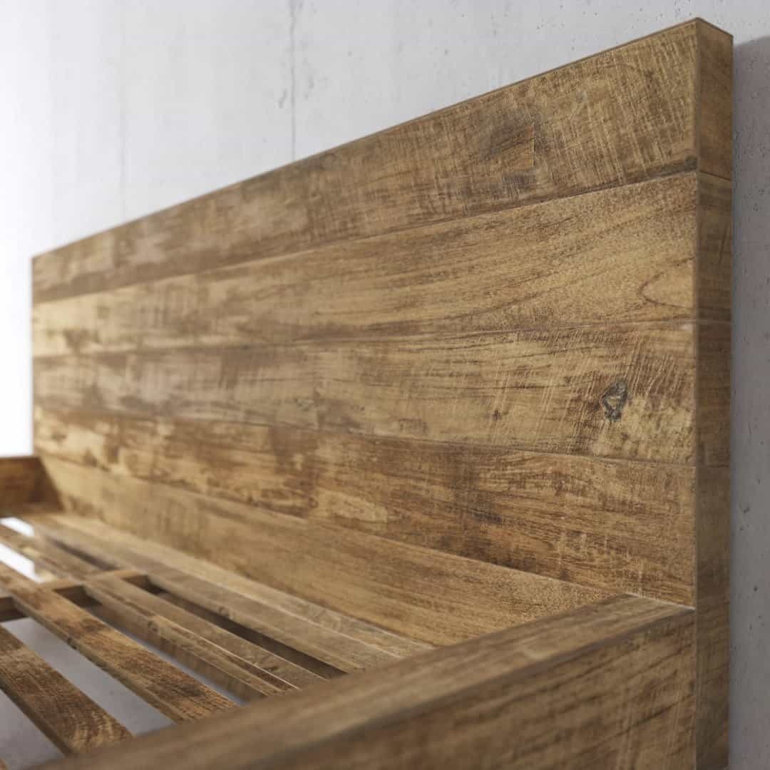 Urban Woodcraft Lugano Bed - Natural (4) Close-up of the Lugano Bed's wooden headboard and frame, highlighting the natural wood grain and texture against a plain background.