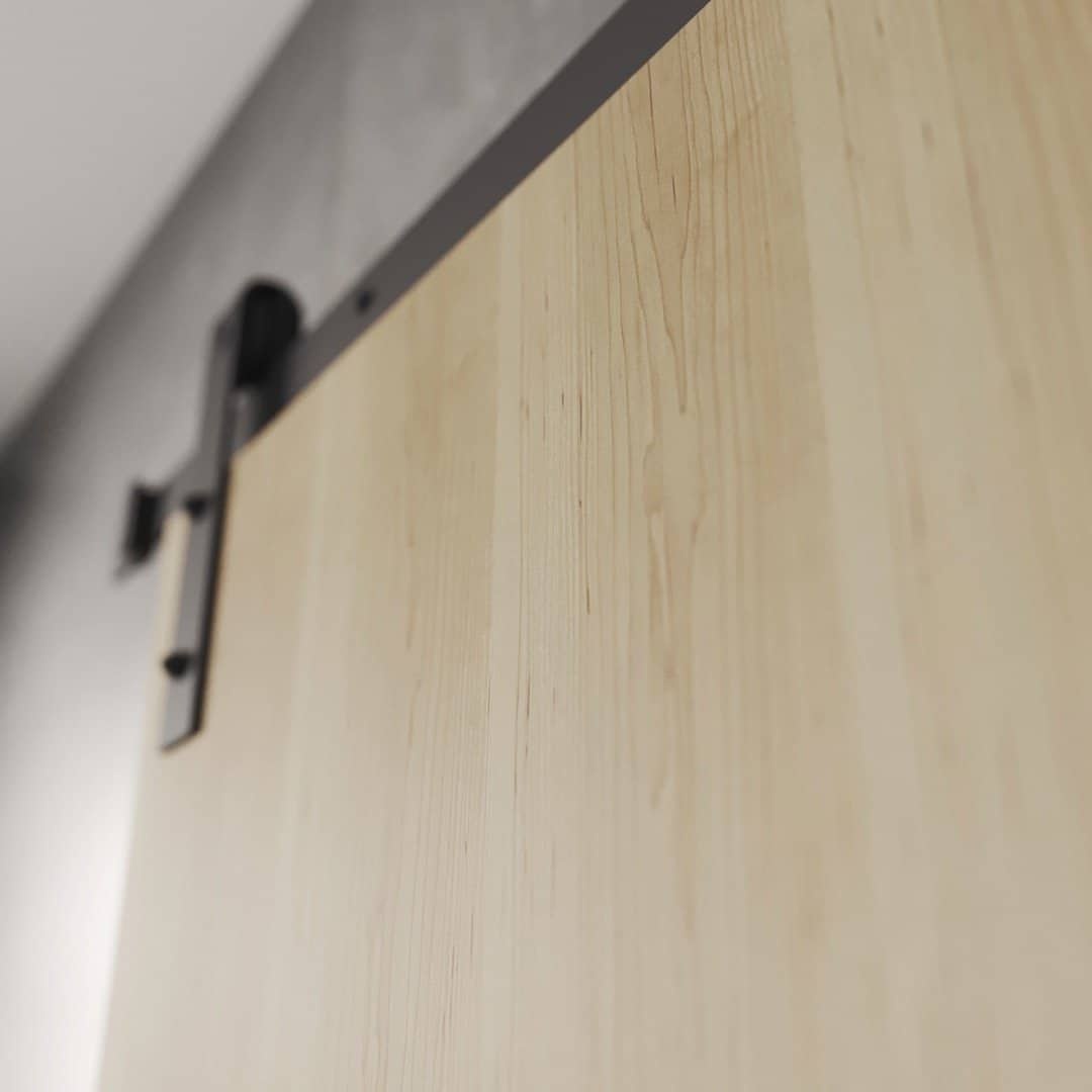 ADDITIONAL (IMAGE 2) FL.MV - Flushed Maple Vaneer DOF Close-up of the Nordic, Walnut Barn Door (83" x 40") mounted on a black track system. The background is a blurred wall.