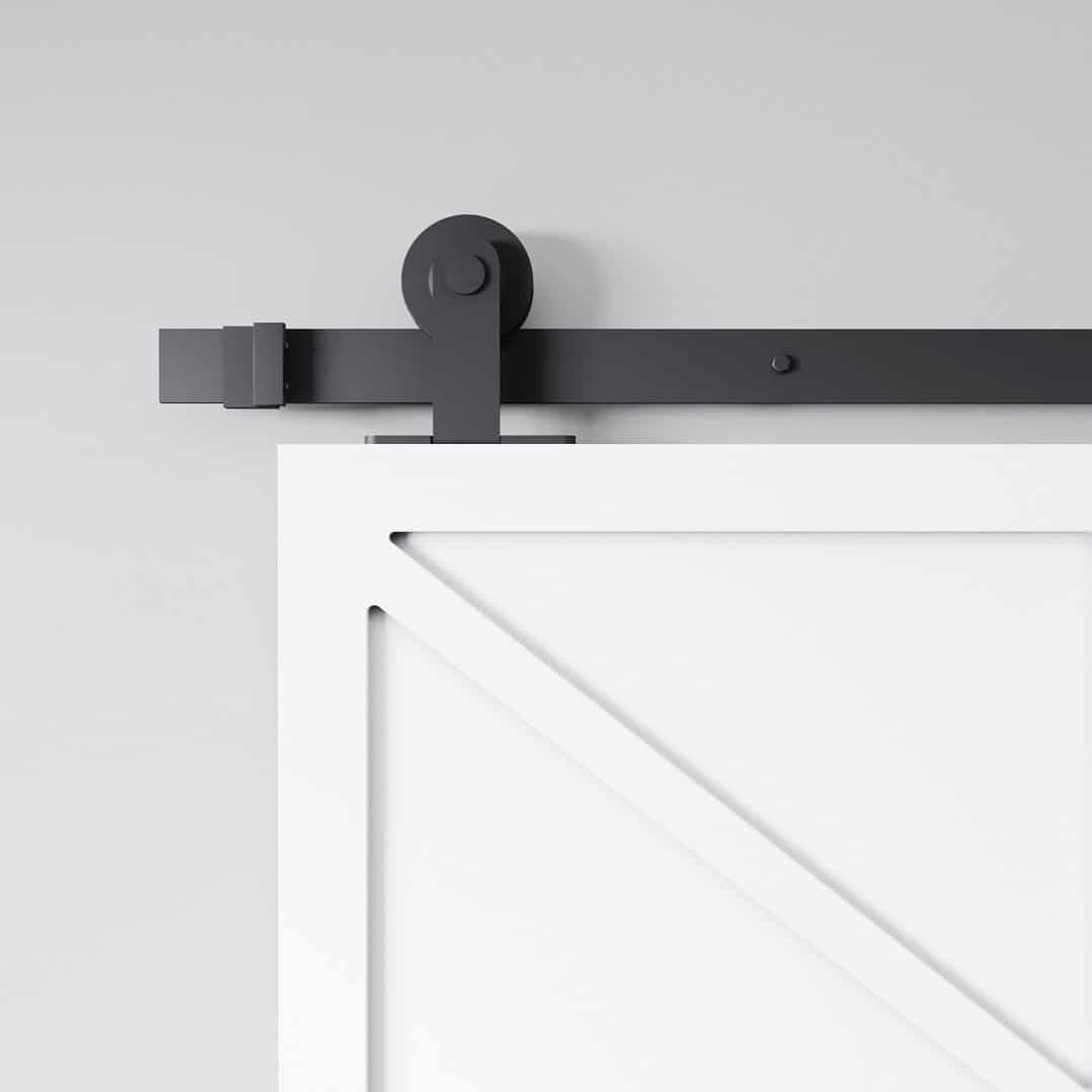 Canal Barn Door White (2) Close-up of the Canal White Barn Door (83" x 40") with a black metal track and roller, set against a gray wall.