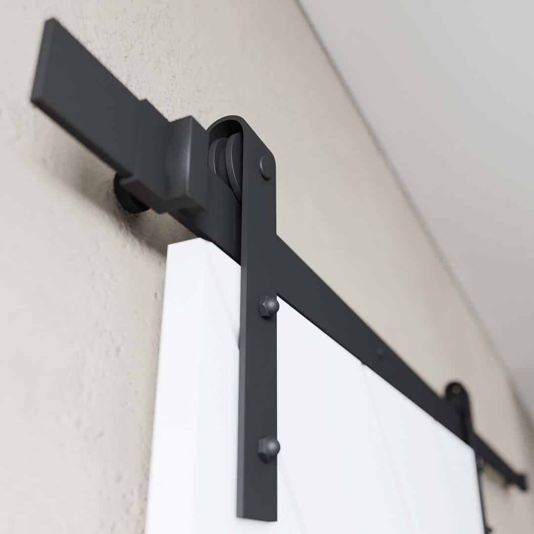 PRESTIGE WHITE (4) Close-up of the sliding barn door track system from the Prestige, White Barn Door (83" x 40") set, showing the mounting hardware fixed to a wall.