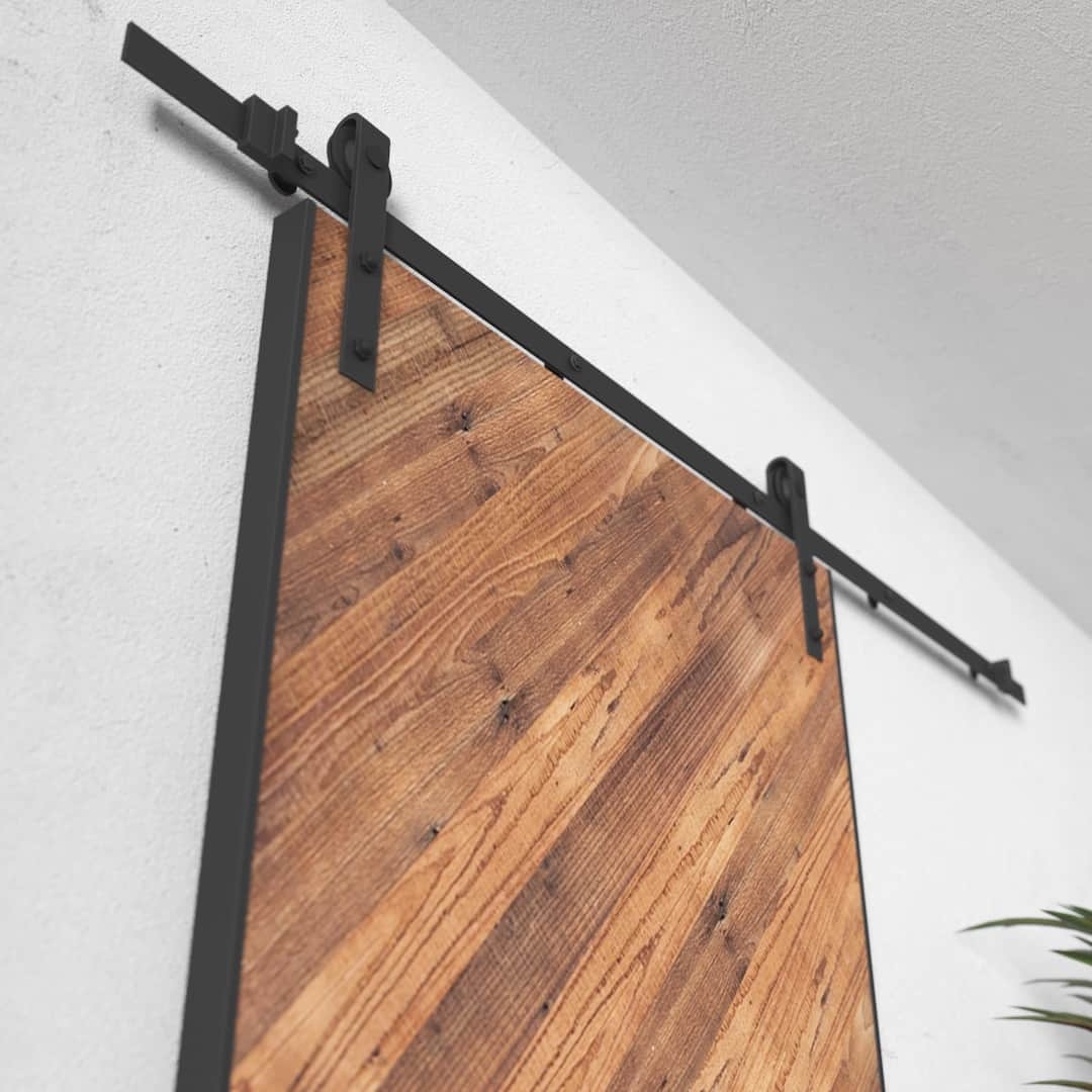 Urban Woodcraft Lucas 40in Reclaimed Wood Arrow Barn Door 3 Close-up of the Lucas reclaimed wood barn door (83" x 40") mounted on a black metal track system, set against a white wall.