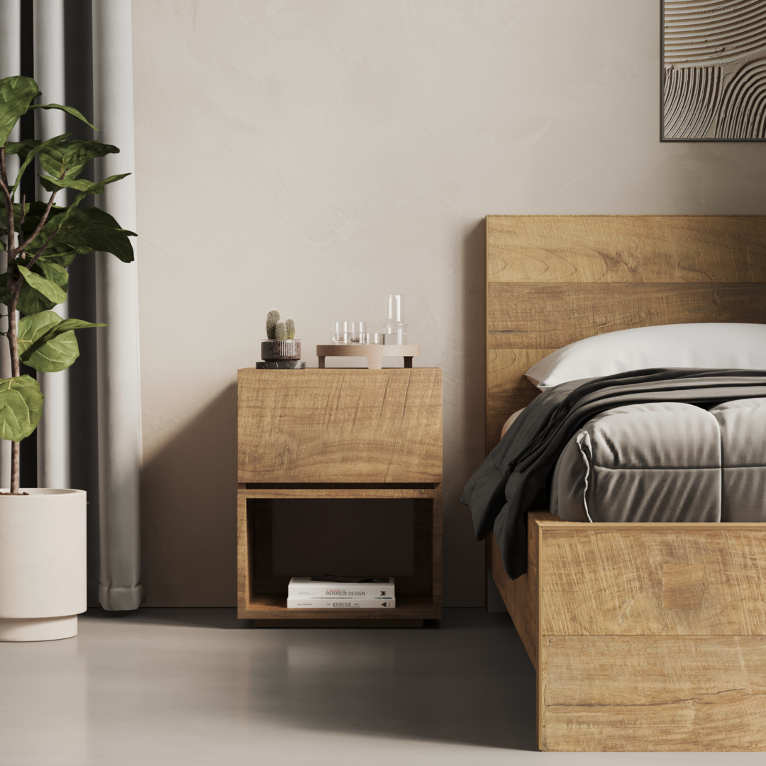 Burma Nightstand - 3 A modern bedroom features a wooden bed accompanied by the stylish Burma Nightstand. The Burma Nightstand holds books, a plant, and various decorative items. A large plant is positioned next to the nightstand while framed artwork adorns the wall.