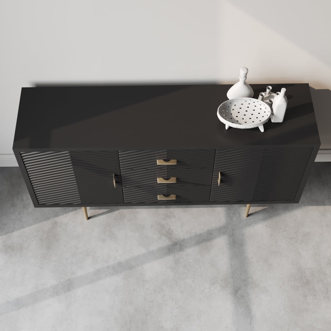 Arista 60 Side Cabinet Black -e The Arista 60" Sideboard (Black) features two cabinets and three central drawers with gold handles. It is elegantly adorned with decorative items, including a white polka-dotted bowl and three white figurines on top.