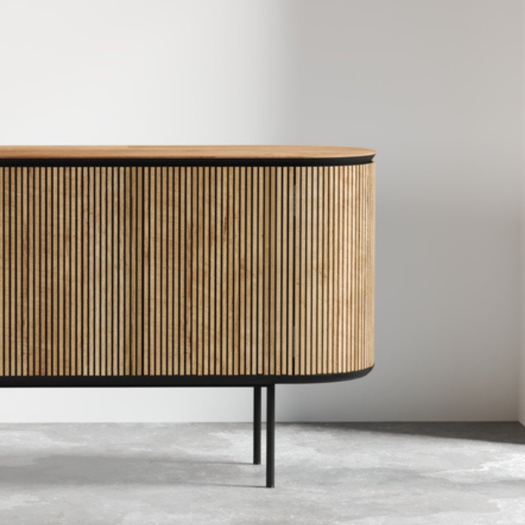 Untitled-design-3.jpg The Bolivar Dining Buffet, featuring vertical slats and slim black metal legs, is positioned against a plain white wall on a gray floor.