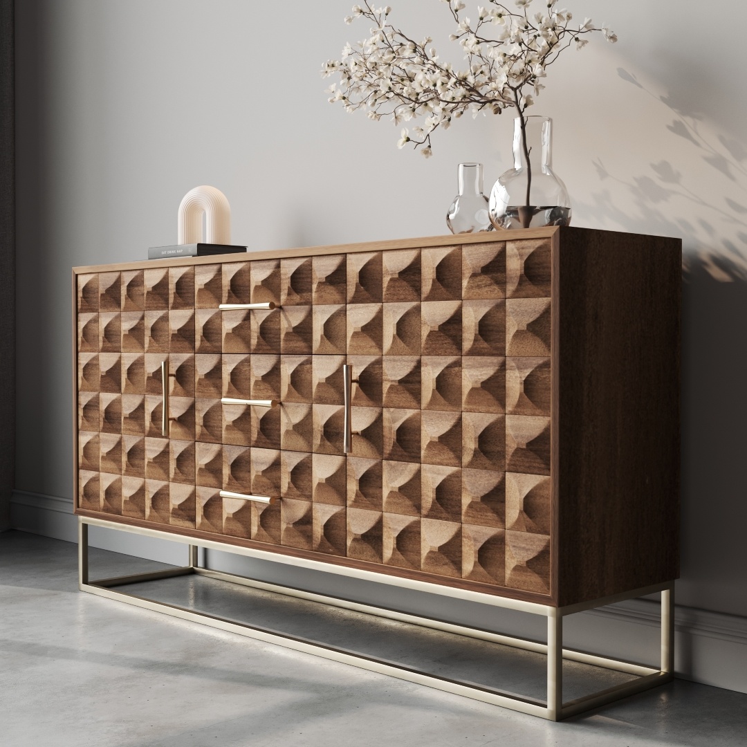Wadi 57 Side Cabinet-c The Wadi 58" Sideboard, featuring geometric designs on the drawers and set against a plain wall, stands elegantly on a metal base. It's adorned with vases, a small lamp, and white flowers.
