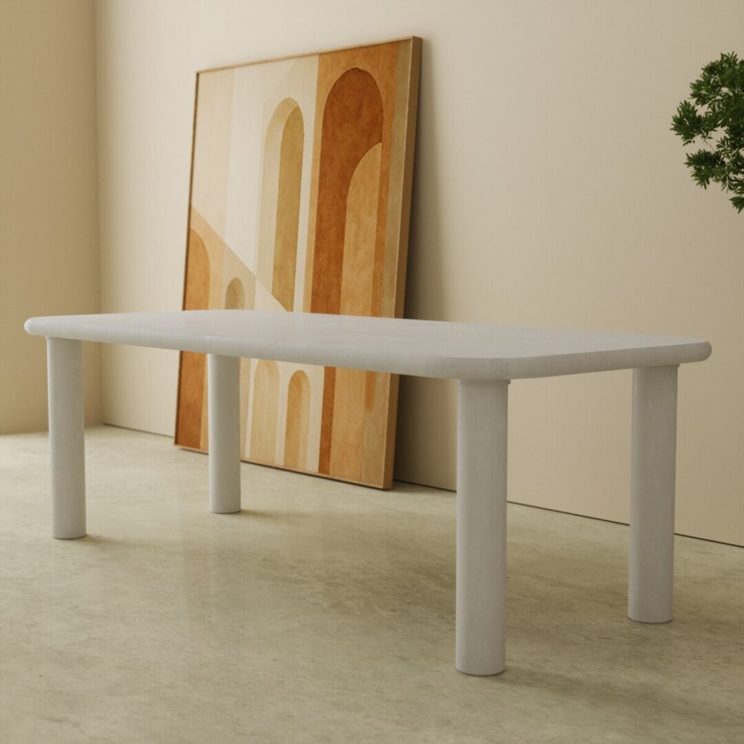 90 Aero Modern Oval Dining Table in white 2 A minimalist room featuring the Aero Modern Oval Dining Table in white, a large abstract painting leaning against the wall, and a partially visible green plant on the right.