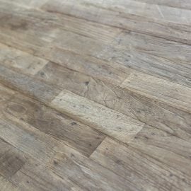 Close-up view of the Metal Dining Table (Natural) featuring a wooden top with visible grain patterns, knots, and varying shades of brown.