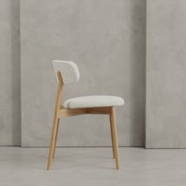 The Alto 20" Dining Chair (Wood), featuring a light-colored cushioned seat and backrest, is placed in front of a textured gray wall.