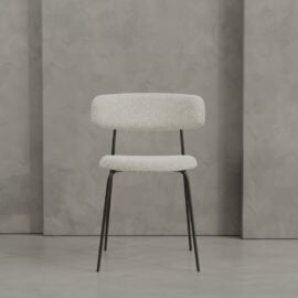The Alto 20" Dining Chair (Metal) features a white upholstered seat and backrest with slim black metal legs, set against a gray textured wall.