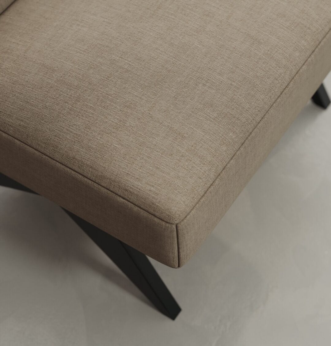 5 Laurel A close-up of the Laurel 27" Lounge Chair shows its beige upholstered cushion and black angled legs, set on a light-colored floor.