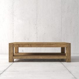 Rectangular wooden coffee table with a lower shelf, placed on a light-colored tiled floor against a plain concrete wall.