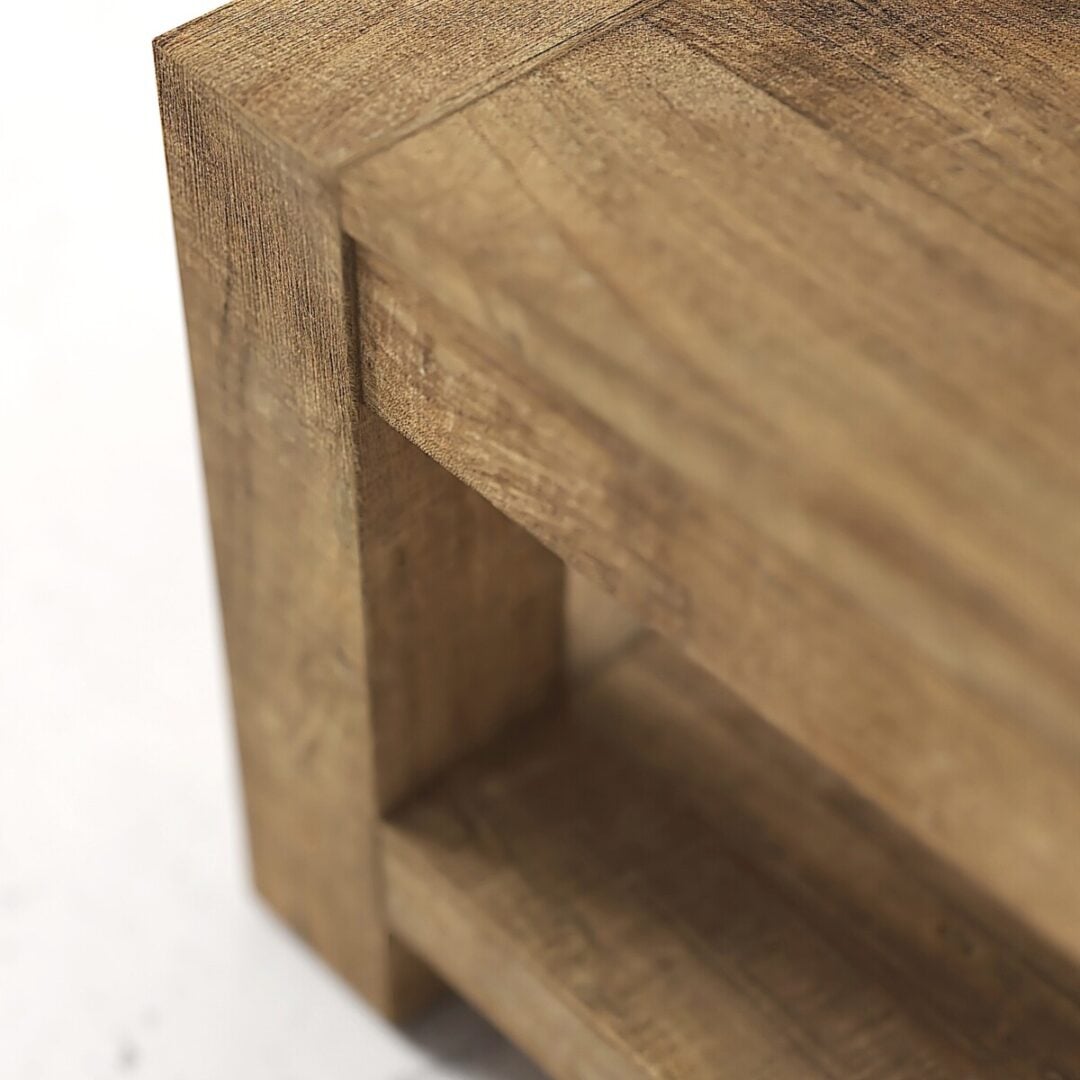 Villa Coffee Table 60 07 Close-up of the corner of a wooden table or shelf, showing its grain texture and right-angled design.