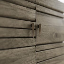 Close-up of the Kava Sideboard, featuring horizontal grooves and two metallic, tapered handles at the center.