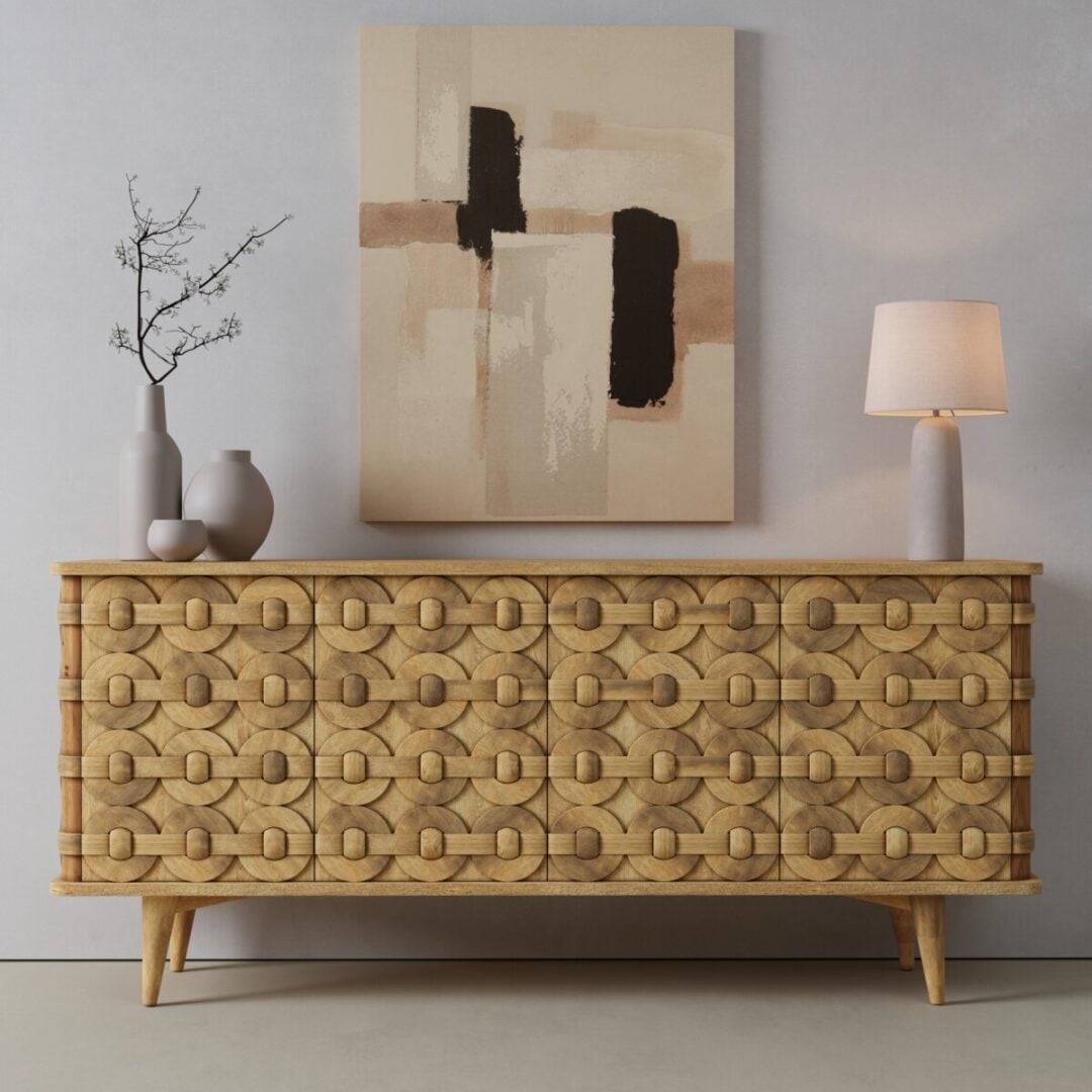 Kinta 71in Sideboard-01 The Kinta Sideboard with geometric patterns stands against a gray wall, topped with vases, a branch, and a table lamp; abstract art hangs above.