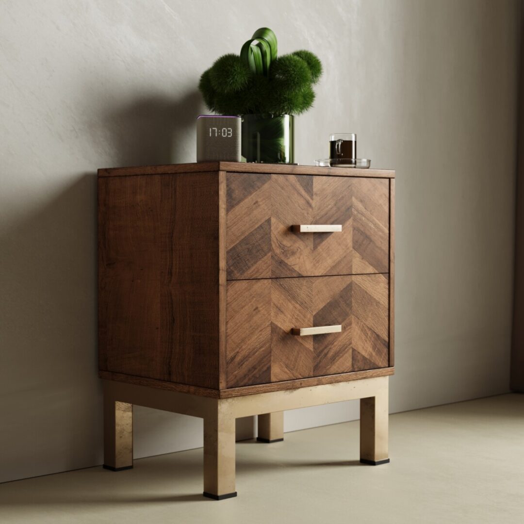 The Zera Sideboard, a wooden piece with two drawers and metallic legs, holds a digital clock, green vase, and glass tumbler against a light-colored wall.