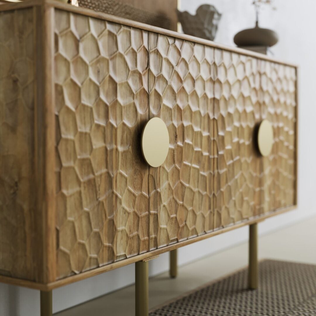 Luna Sideboard-03 The Luna Sideboard, featuring a honeycomb-patterned front, round gold handles, and gold legs, is displayed on a textured rug.