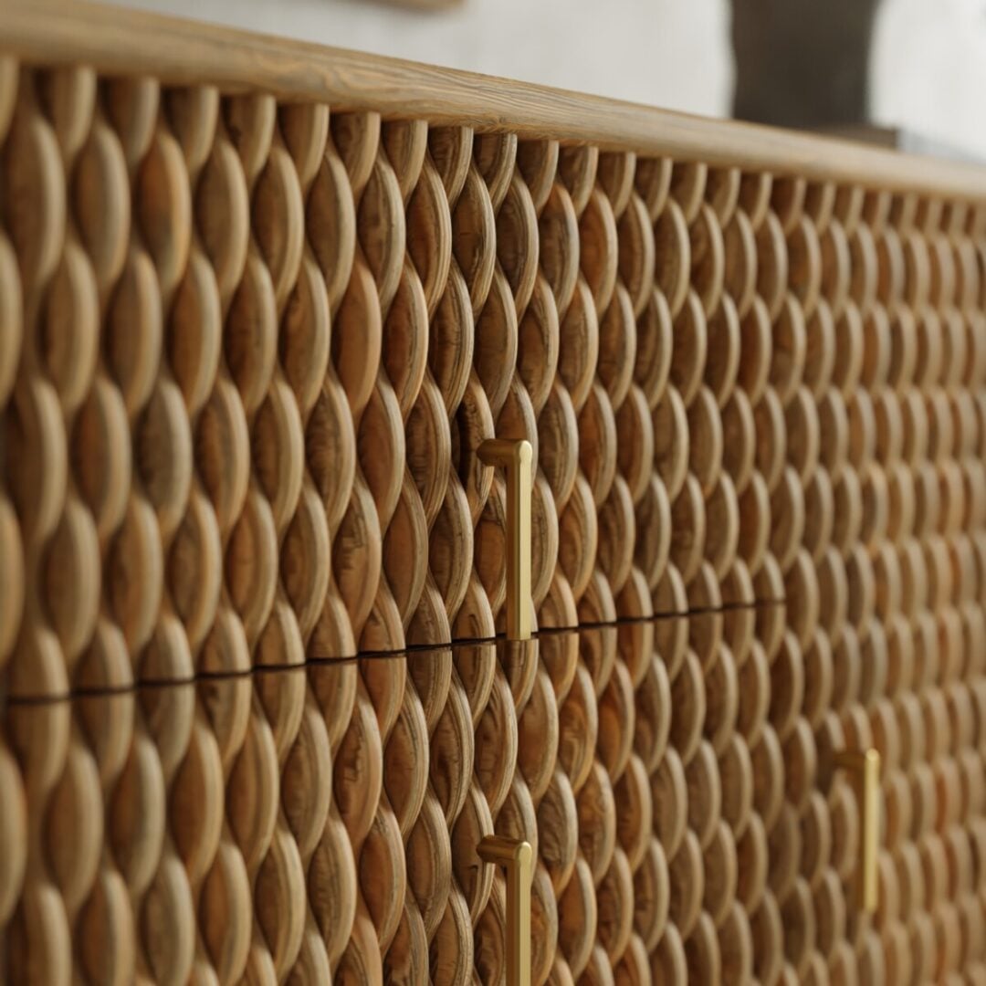 Salaro 60in Sideboard-04 Close-up of a wooden cabinet with a textured, oval-patterned surface and vertical gold handles.