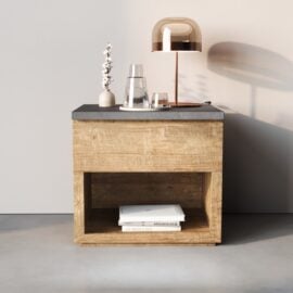 The Nox Nightstand features an open lower shelf for books, while its top surface displays a glass pitcher, glass, small vase, and metallic lamp.