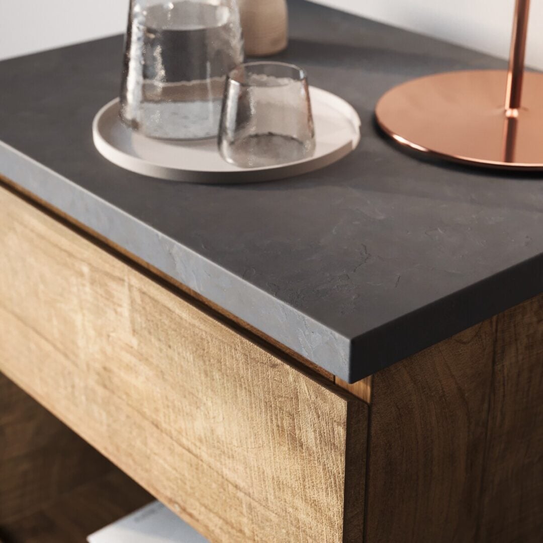 Nox Nightstnad - 4 A close-up of the Nox Nightstand, showcasing its dark stone-inspired top, with a round tray holding glassware and a copper-based lamp.