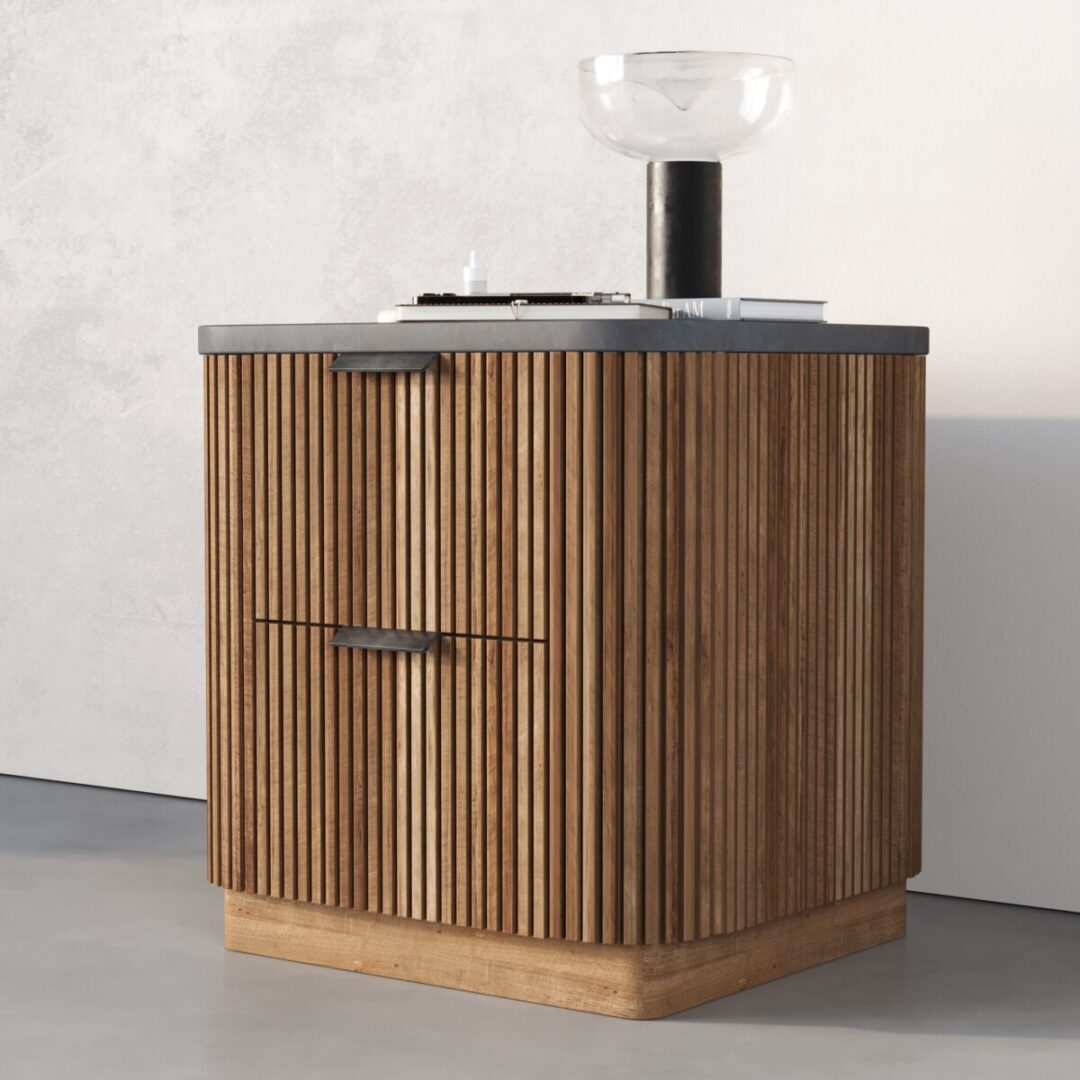 Osaka Nightstand The Osaka Nightstand is a small wooden cabinet with vertical slats, a dark countertop, and is styled with a glass bowl and a black cylindrical object on top.