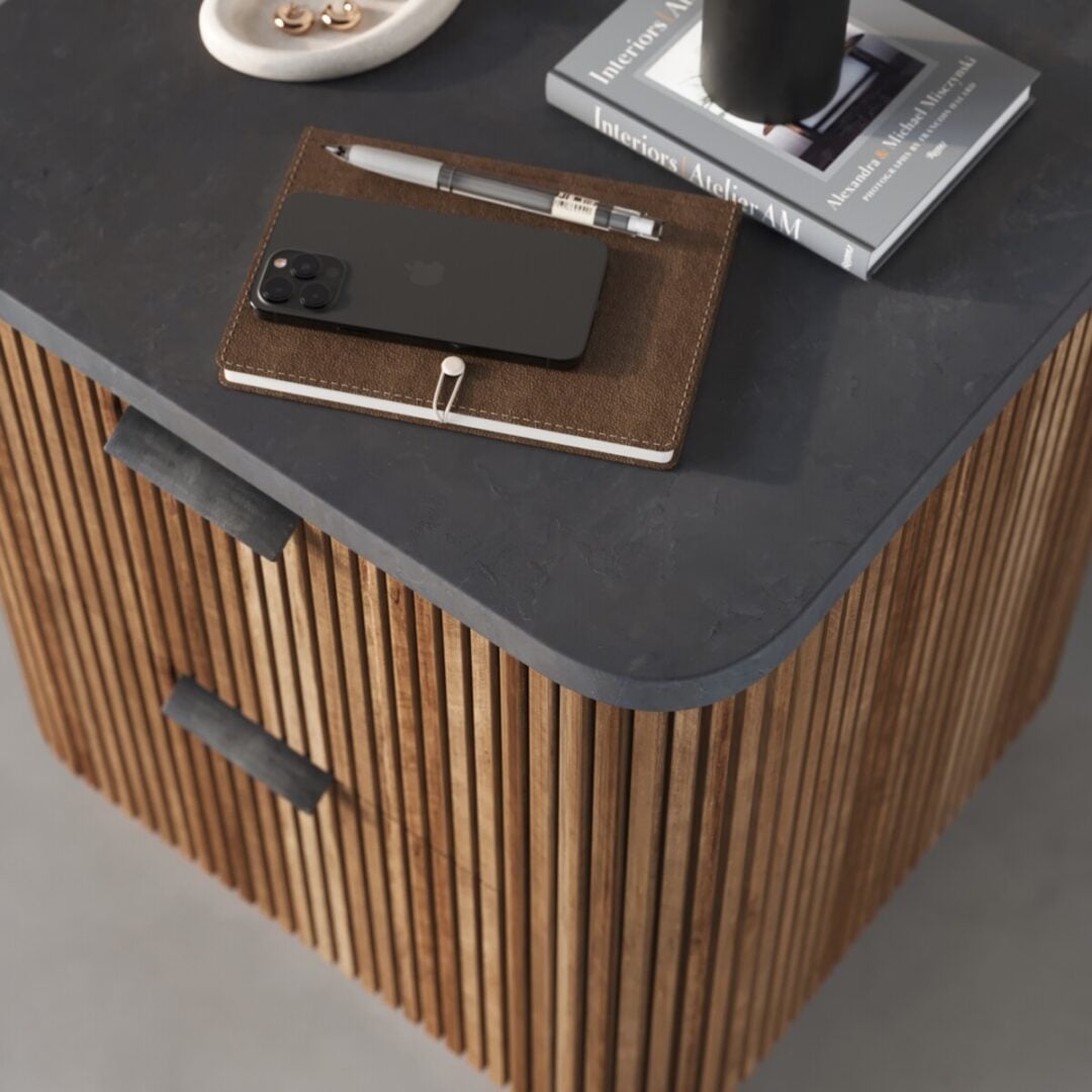 Osaka Nightstand The Osaka Nightstand with black handles displays a pen, brown notebook, smartphone, books, and a jewelry dish on its dark wooden surface.