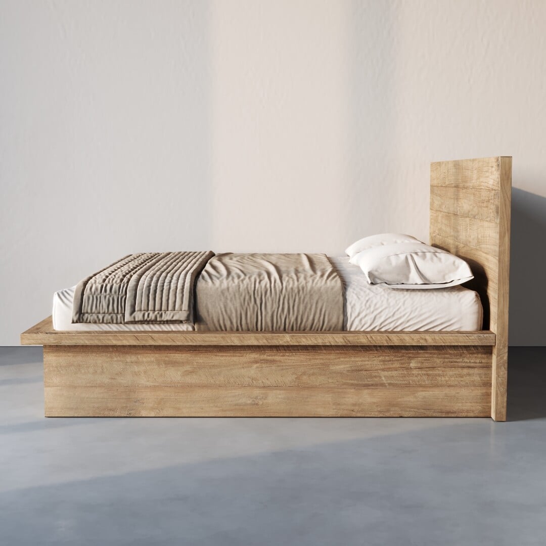The Montara Bed features a wooden frame with white bedding, two pillows, and a folded gray blanket at the foot, set against a plain light wall on a smooth floor.